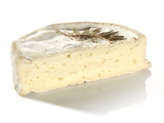 a slice of Coulommiers cheese with a bloomy edible rind