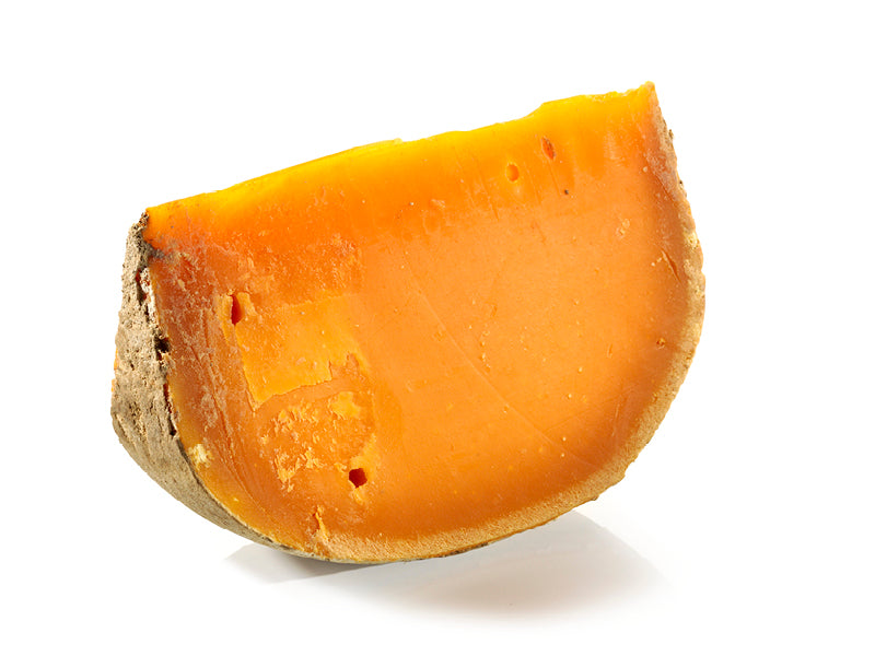 a piece of Mimolette cheese