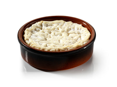 Saint-Marcellin cheese kept in a brown container 
